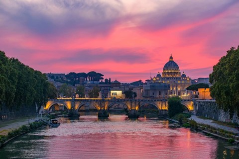Sunset view of St. Peter's Basilica, Ponte Sant'Angelo, and Tiber River in Rome, Italy, Europe