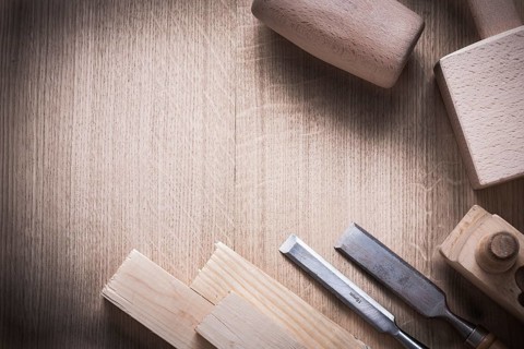 Wooden bricks mallets planner flat chisels on wood background construction concept
