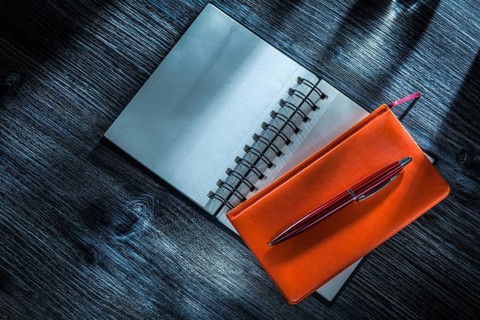 New pocketbooks pen on vintage wooden board