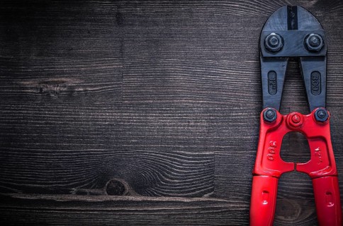 Metal steel cutter on wooden board copyspace construction concept