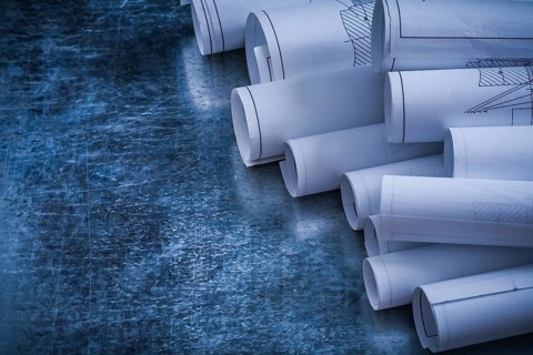 Metallic vintage background with heap of white blueprint rolls building and architecture concept