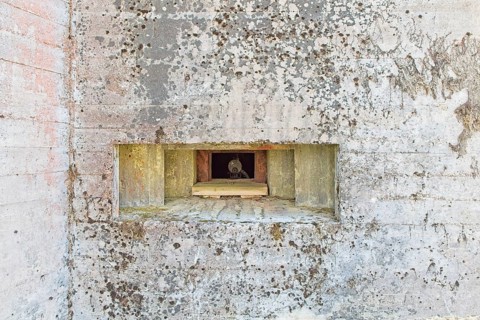 Closeup of an old machine gun opening in a old concrete WW2 bunker with machine gun, Hostikka,