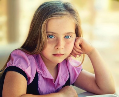 Blond relaxed sad kid girl expression blue eyes portrait