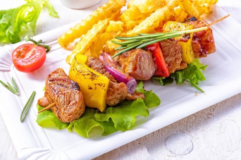 Shish kebab skewers with marinated ham meat paprika and red onion
