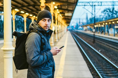 Sopot Fast Urban Railway station. young man standing and waiting train on platform. tourist travels
