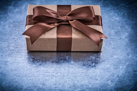 Packed gift boxes with brown ribbon horizontal version holidays concept