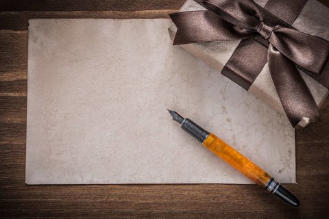 Present box brown bow paper fountain pen on wood board