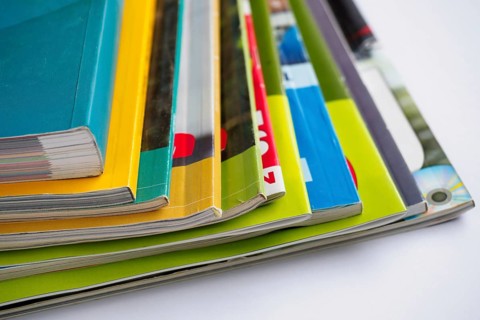 Stack of magazines on white background