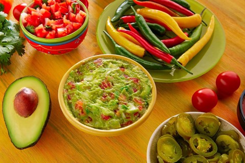 Mexican food mixed guacamole nachos chili sauce dipping cheddar cheese lemon pico de gallo