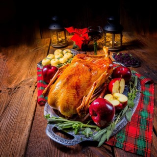 Festive stuffed roast goose with red cabbage and dumplings