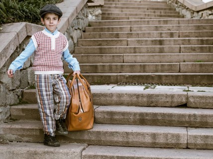 Exterior stairs and child with vintage bag. Vintage clothes style