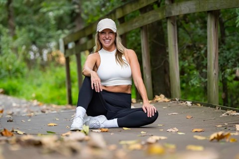 A gorgeous blonde model, dressed in sleek workout clothes, takes a well-deserved break after an
