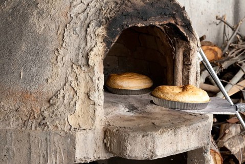 Fresh homemade bread cooked on a traditional clay oven. Home bakery