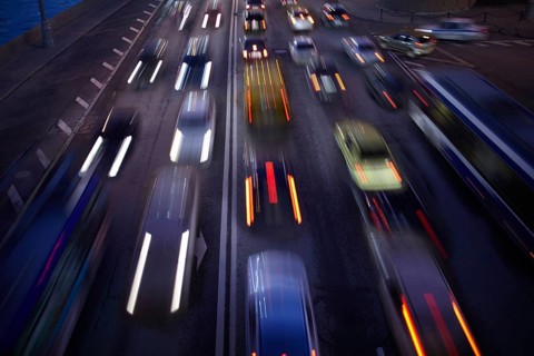 Car traffic at night. Motion blurred background. Long exposure shot