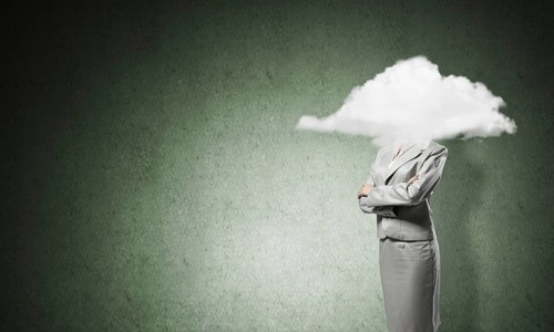 Businesswoman with arms crossed on chest and head in cloud