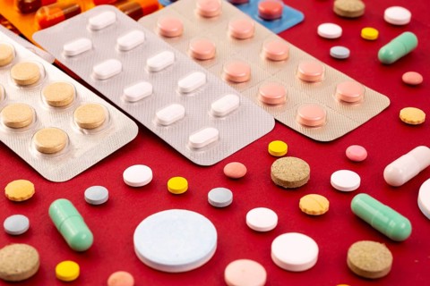 Different colorful pills and capsules in packs - blisters. Global pharmaceutical industry for