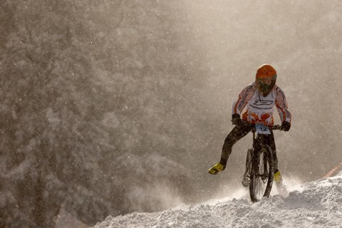 Sofia, Bulgaria - 22 January, 2022: Cyclist rides a bike downhill during an extreme snow riding