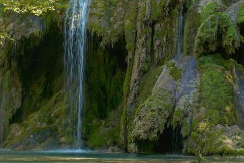 The tufa waterfall near Arbois. Crystal clear waterfall, powerful waterfall