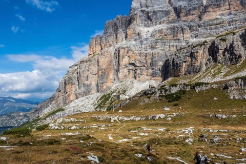 Male mountain climber on a Via Ferrata in breathtaking landscape of Dolomites Mountains in Italy.