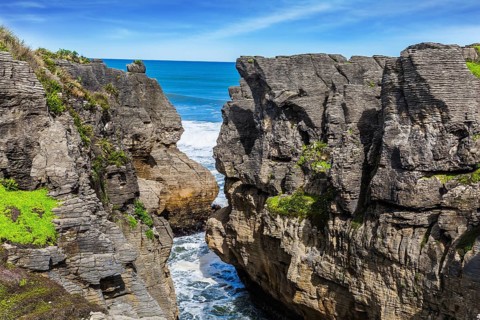 Narrow fjord among unique pancake rocks, natural wonder of Paparoa National Park. Scenic coastline,