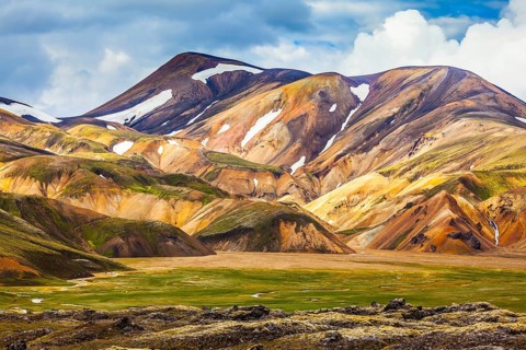 National Park Landmannalaugar. On the gentle slopes of the mountains are snow fields and glaciers.