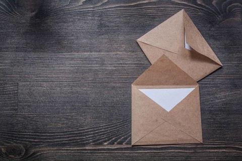 Vintage envelopes on wooden board copy space