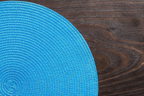 Wickered round mat on vintage wooden board