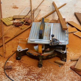 Circular table saw carpenter tool and sawdust in deck installation
