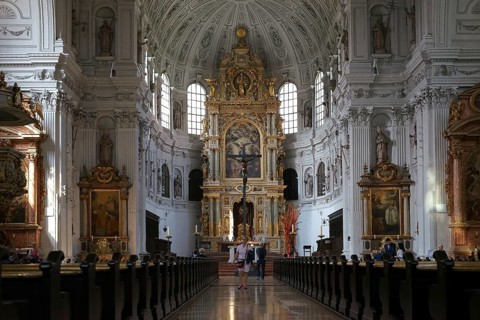 Munich, Germany - June 30, 2018: The altar and the golden and sacredly decorated interior of St.
