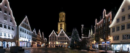 Panoramic night photo of the historic buildings around the market square with Christmas tree and