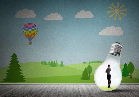 Businesswoman inside light bulb in room against nature drawn concept