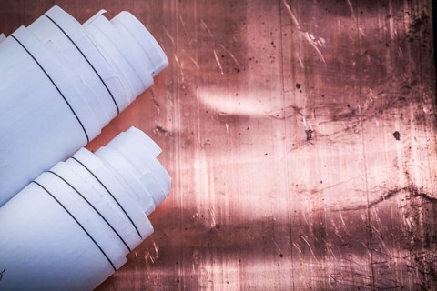 Blueprints on coppery background construction concept