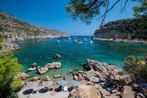 Beach umbrellas and sunbeds, turquoise waters, Anthony Quinn Bay, Faliraki, Rhodes, Dodecanese,