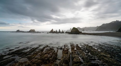 A long expiosure view of the Playa de Gueirua beach on the Costa Verde of Asturias
