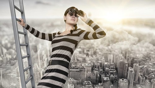 woman using a spyglass on top of a ladder
