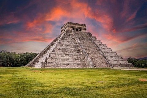 Beautiful clouds at sunrise over the famous Maya pyramid in Yucatan, Mexico that attracts millions