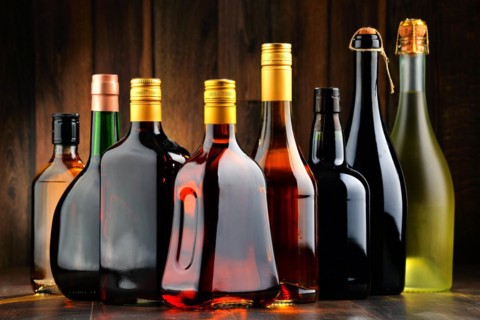 Composition with bottles of assorted alcoholic beverages