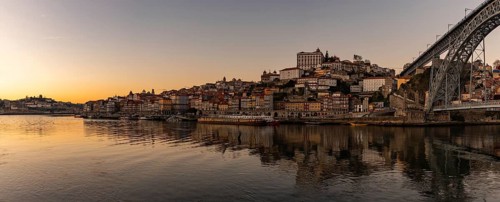 A panorama picture of the Porto cityscape and the Douro river at sunset