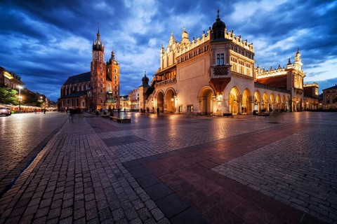 Krakow city in the evening in Poland, Main Square in the Old Town, illuminated St. Mary Church and