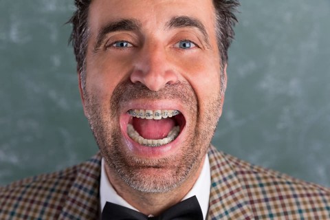 Nerd silly retro man with braces funny expression open mouth