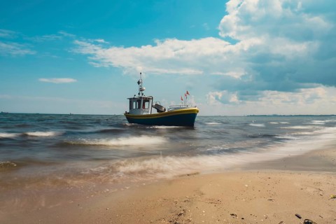 Fishing boat on the beach in Sopot, Poland. Magnificent long exposure calm Baltic Sea. Wallpaper
