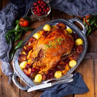 Roast duck with potato dumplings and plums