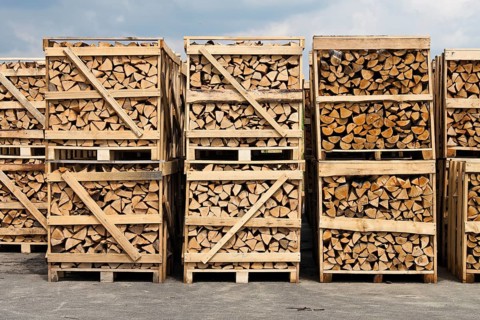 A large stack of firewood. Packed on pallets Austria