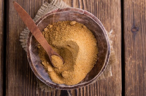 Portion of Coco Sugar (selective focus) on a vintage wooden table