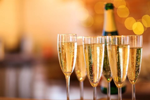 Champagne glasses on gold background. Party and holiday celebration concept