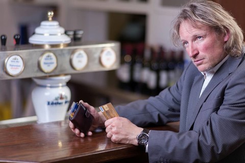 Man in suit paying at a counter with a credit card, Mindelheim, Bavaria, Germany, Europe