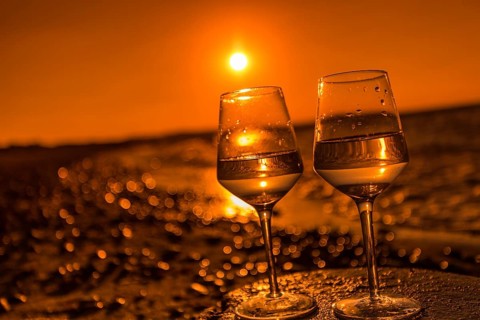 Wine on the baltic sea beach at sunset