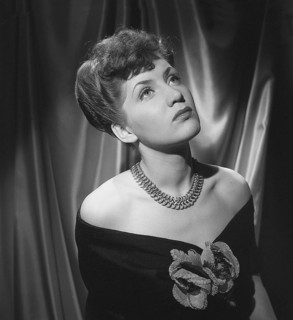 In the 1940s. Actress Barbro Kollberg pictured in studio wearing a shoulderless dress with a