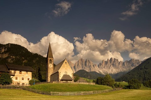 The Sankt Magdalena church in front of the Geislergruppe mountain tops in the Italian Dolomites