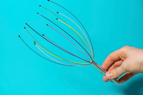 Scalp massager for home. Close up of scalp massaging brush for hair growing routine. Anti stress